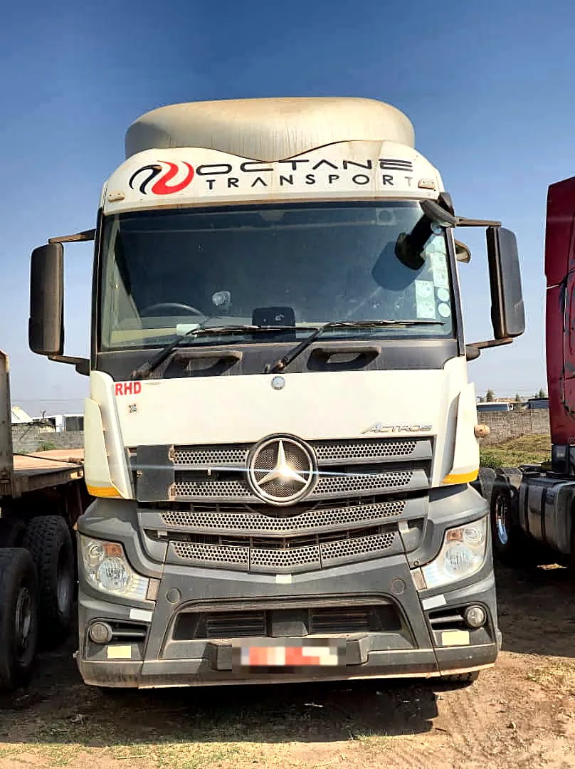 Front view of a white Mercedes-Benz Actros prime mover with Octane Transport branding on the roof fairing