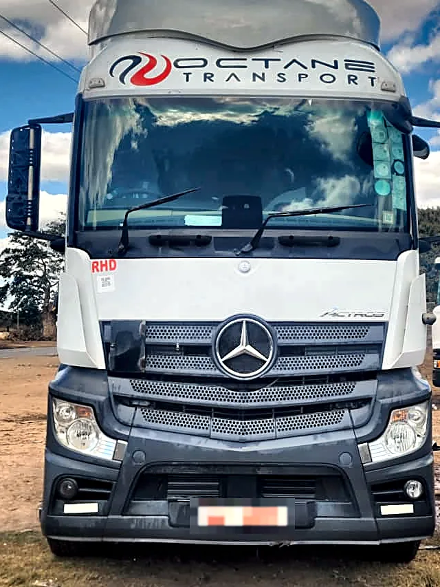 Close-up front view of an Octane Transport Mercedes-Benz Actros cab and grille